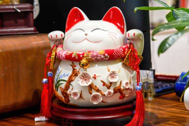 Şirin seramik bir kedi kumbarasına yakın çekim.