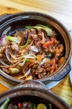 A pot of delicious and authentic traditional Cantonese cuisine in a hot pot, fat beef in a hot pot