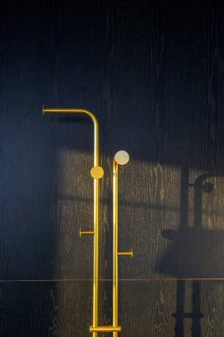 Yatak odasında altın bir elbise askısı.