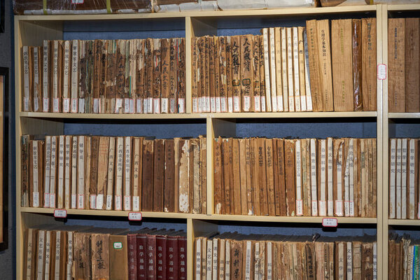 Close-up of old and broken old books on bookshelf
