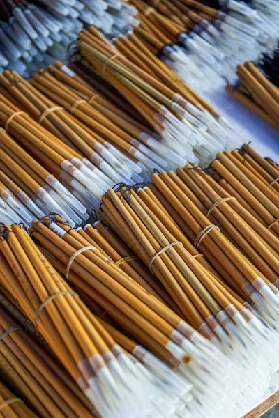 Close-up of various traditional Chinese brushes sold in the market