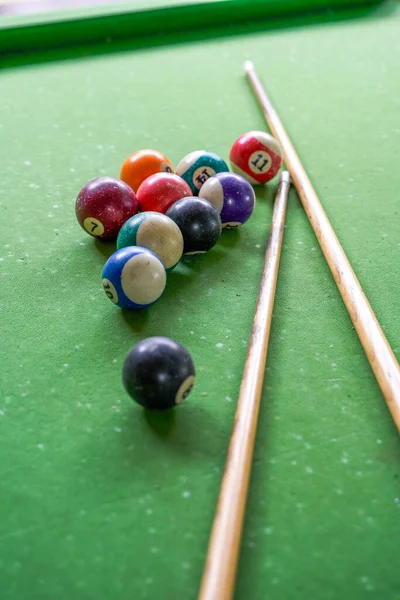 Billiards and pool cues on the pool table