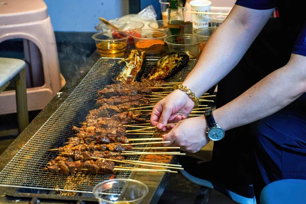 A person is making barbecue, charcoal kebab