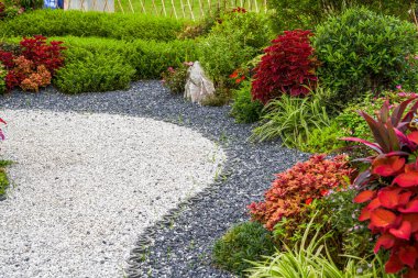 Walking path and zen-like white pagoda gravel landscape in Japanese garden