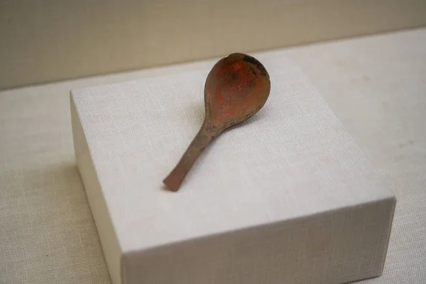 Ancient Chinese cultural relics from the Han Dynasty in the museum, red pottery spoons