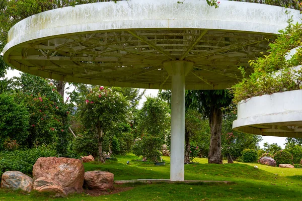 Close-up of ring-shaped pavilion buildings and green plants in the park