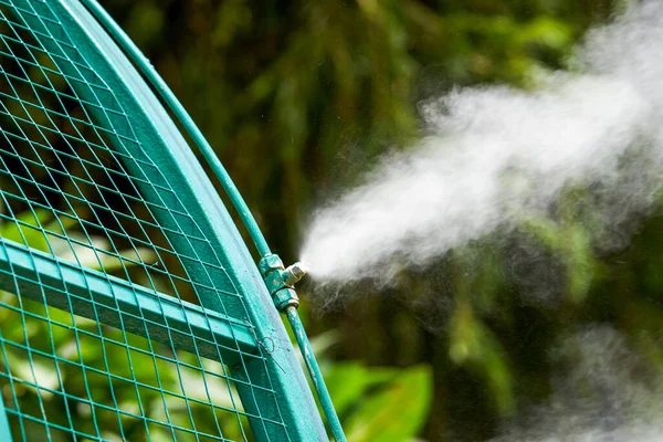 Iron frame sprinklers for watering plants in the garden are spraying water