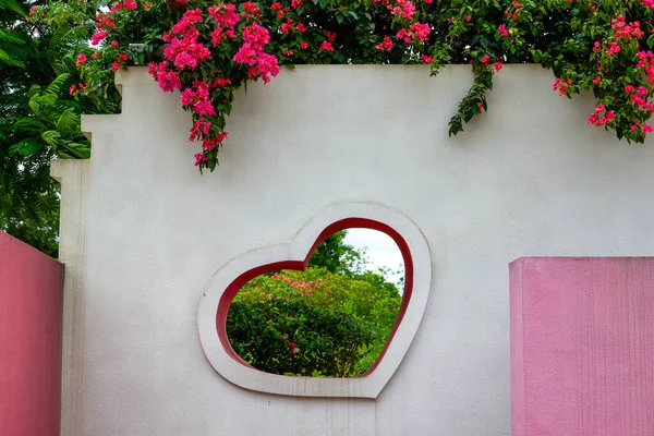 Close-up of hearts and flowers on pink wall