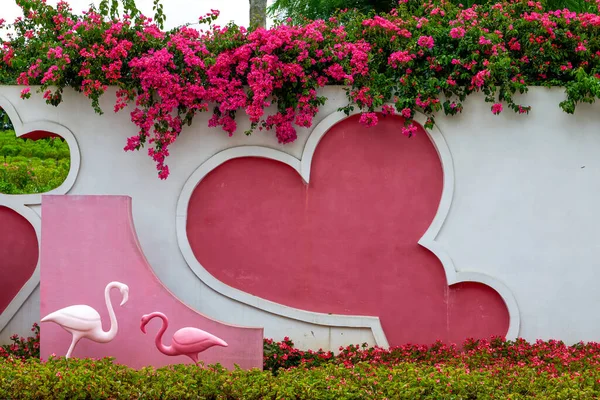 Close-up of hearts and flowers on pink wall