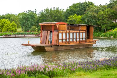 This traditional Chinese wooden boat is moored on the lake in the park