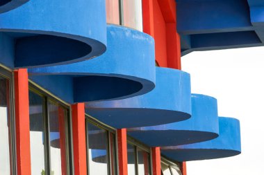 Close-up of modernist buildings in contrasting red and blue colors