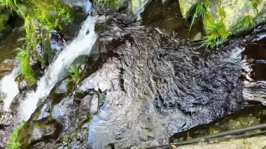 Slow motion video of small waterfall flowing in mountain stream in Guilin, Guangxi, China
