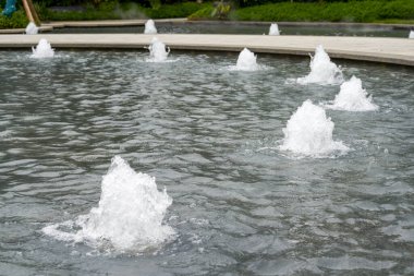 Landscape of man-made flowing water fountain in the park