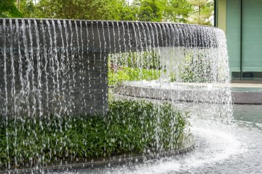 Landscape of man-made flowing water fountain in the park