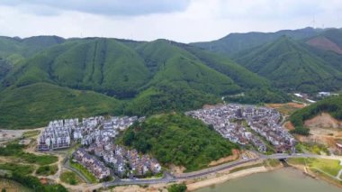 Aerial photography of a group of Chinese-style villas in the outdoor forest and mountains