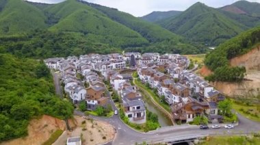 Aerial photography of a group of Chinese-style villas in the outdoor forest and mountains