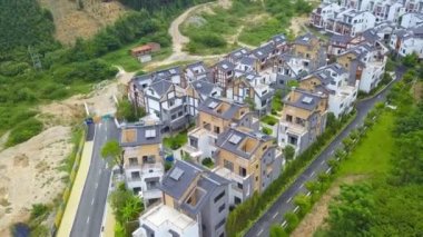 Aerial photography of a group of Chinese-style villas in the outdoor forest and mountains