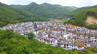 Aerial photography of a group of Chinese-style villas in the outdoor forest and mountains