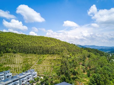Aerial photography of green mountains, blue sky and white clouds on the outskirts of Guangxi
