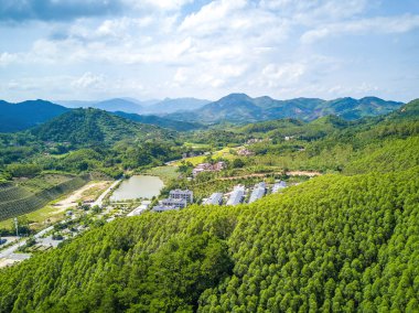 Aerial photography of green mountains, blue sky and white clouds on the outskirts of Guangxi