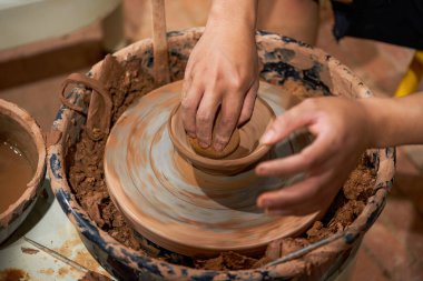 Craftsmen in pottery shop making clay pottery