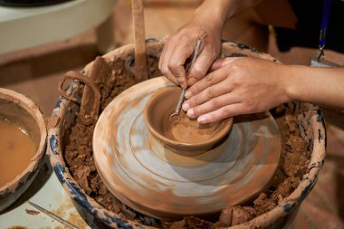 Craftsmen in pottery shop making clay pottery