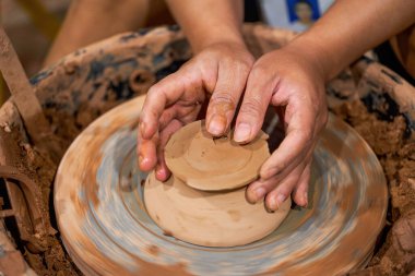 Craftsmen in pottery shop making clay pottery