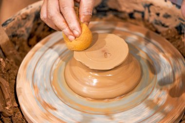 Craftsmen in pottery shop making clay pottery