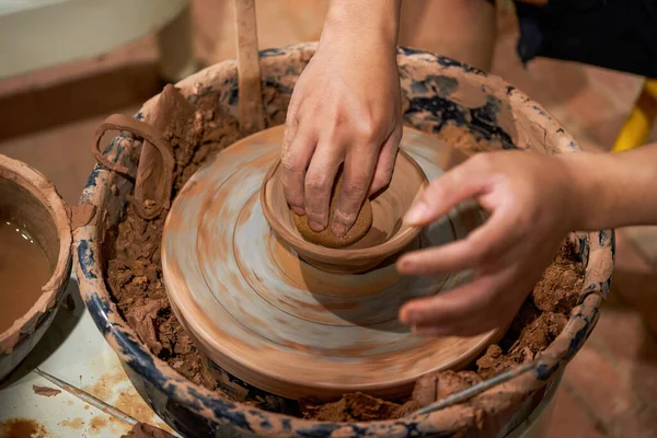 Craftsmen in pottery shop making clay pottery