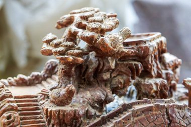 A piece of delicate bird and cloud pine wood carving