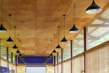 A conference room with wooden ceiling and chandelier