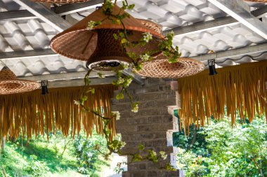 Bamboo chandelier hanging from indoor ceiling