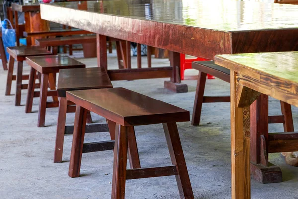 Long table and wooden benches in traditional Chinese restaurant