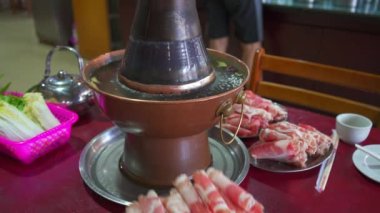 Two people are eating old Beijing hot pot mutton, copper pot shabu-shabu