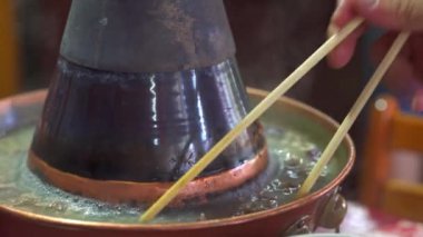 Two people are eating old Beijing hot pot mutton, copper pot shabu-shabu
