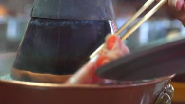 Two people are eating old Beijing hot pot mutton, copper pot shabu-shabu