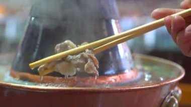Two people are eating old Beijing hot pot mutton, copper pot shabu-shabu