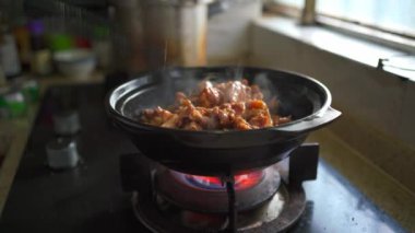 A chef is making a delicious kebab pot, sand ginger chicken