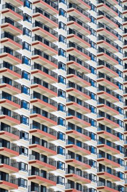 Close up of regular and neat balcony windows on a residential building in the city