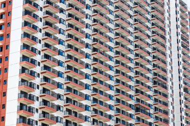 Close up of regular and neat balcony windows on a residential building in the city