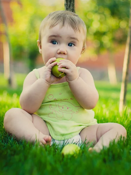 Baby with green apple Stock Photo