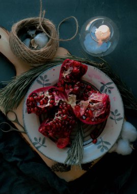christmas food , red pomegranate on a dark background
