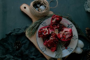 christmas food , red pomegranate on a dark background