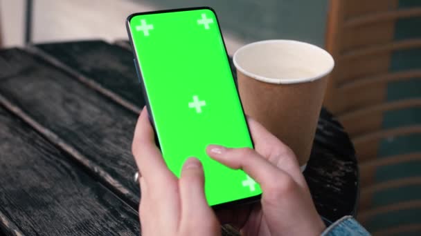 Lviv, Ukraine - May 6, 2022: Hands texting touch holding a mobile telephone with a vertical green screen outside chroma key smartphone technology cell phone street touch message display hand — Stock video