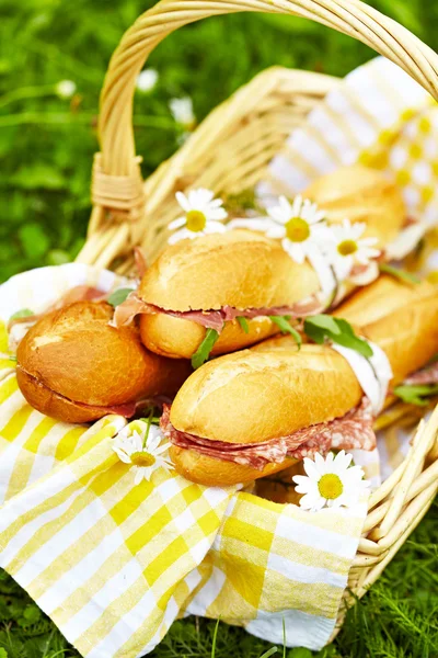 Long baguette sandwiches in basket — Stock Photo, Image