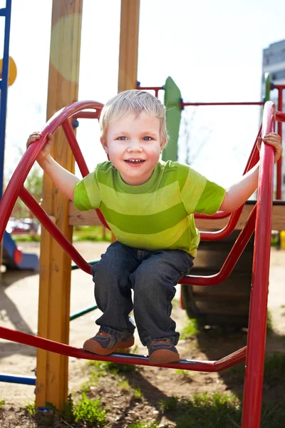 O rapazinho está a brincar no parque infantil — Fotografia de Stock