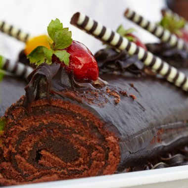 Chocolate roll cake with strawberries clipart