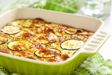 Casserole with cheese and zucchini in baking dish clipart