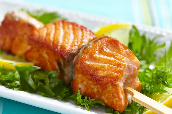 Delicious roasted salmon on skewers — Stock Photo, Image