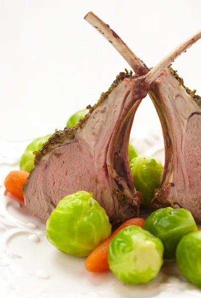 Lamb chops with brussel sprouts and carrots — Stock Photo, Image